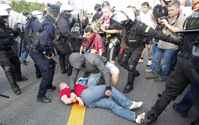 A Polish soccer fan lies on the ground after clashing with Russian supporters in Warsaw